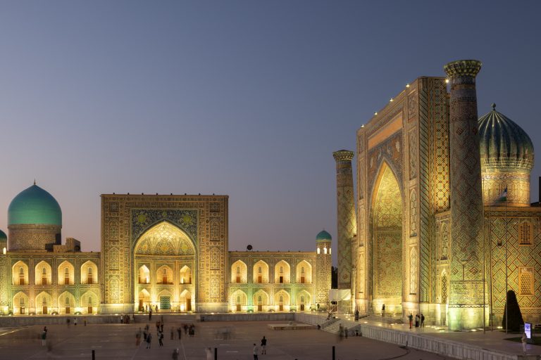 The stunning Registan Square lit up at night in Samarkand, Uzbekistan.