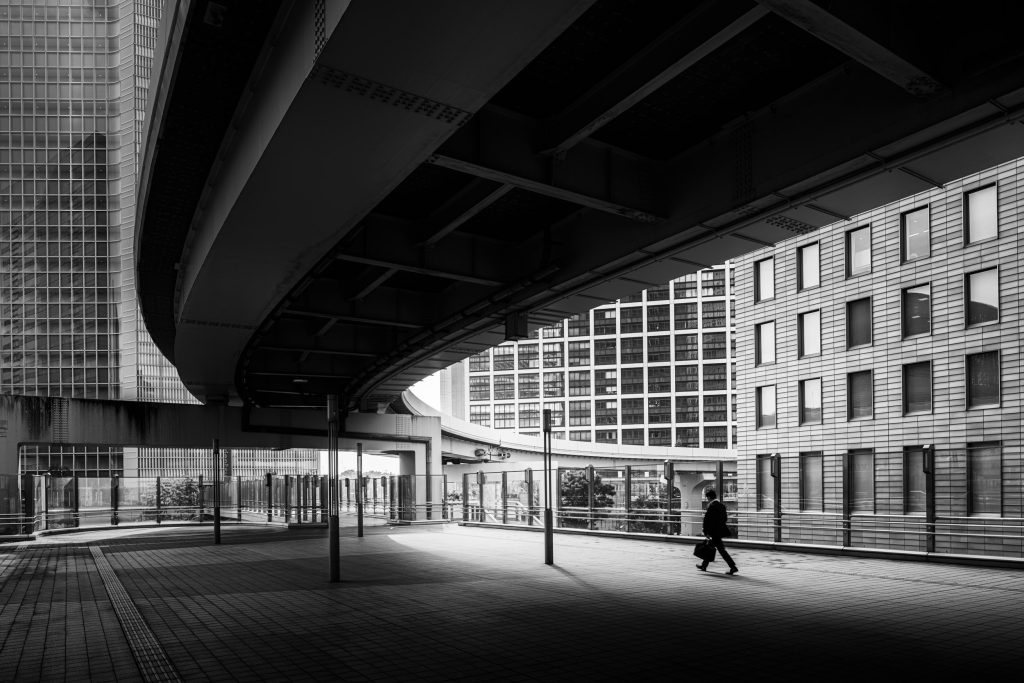 A businessman walks to work near to a metro station in central Tokyo, Japan.