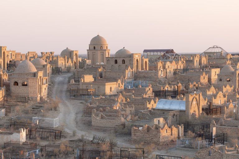 The evening light illuminates the Mizdarkhan cemetary near to Nukus, Uzbekistan. Considered a sacred site, the Mizdarkhan cemetary near to Nukus contains a number of mausoleums. Some such as that of the Mazlum Khan Slu mausoleum date back to betwen the 12th and 14th centuries.